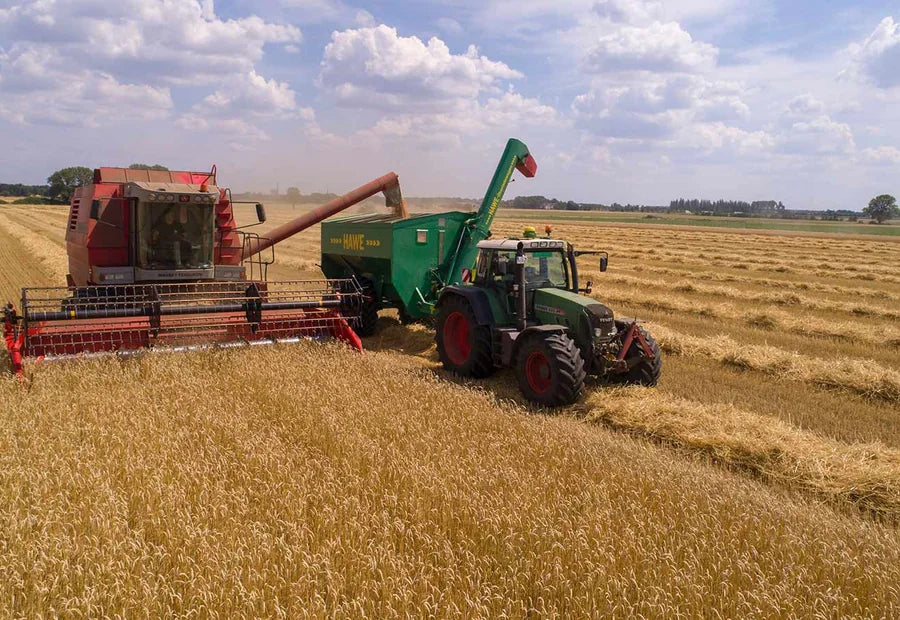 Tractor and combine working in a field