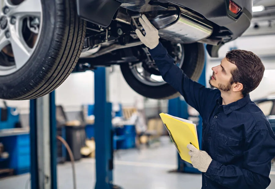 Automotive technician inspecting a vehicle